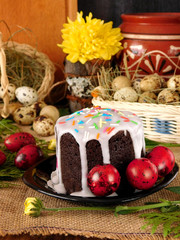 Easter composition made of cake, red coloured eggs and flowers