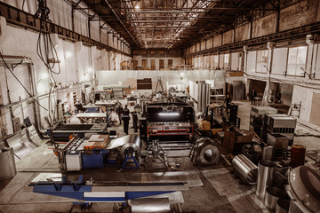 Industrial factory with equipment tools in large workshop or warehouse