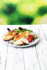 Grilled Chicken Breast with Salad and cherry tomatoes.