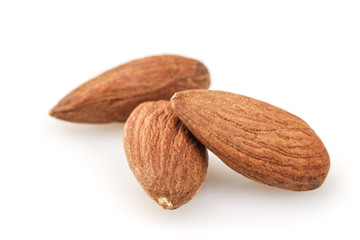 peeled almond seed on white background
