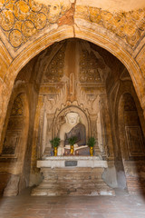 Front view of a statue of sitting Buddha at the Khaymingha Temple complex in Bagan, Myanmar (Burma).