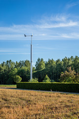 Fototapeta na wymiar Electric windmill in countryside forests.