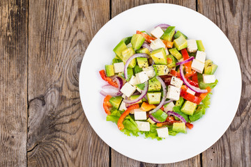 Delicious salad with avocado, feta and sweet pepper