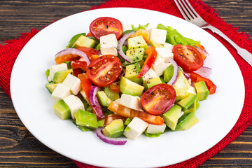 Dietary salad of fresh vegetables with avocado and goat cheese
