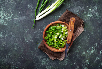 Chopped green onions on concrete background