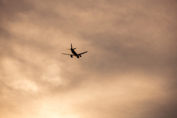 Airplane take off silhouette with sunlight in background.