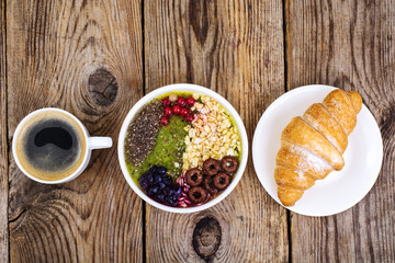 Espresso, croissant and fruit dessert for breakfast