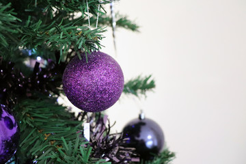 Closeup of Purple Sparkly Bauble Hanging on Christmas Tree