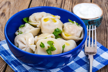 Cooked dumplings in blue bowl