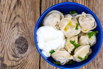 Cooked dumplings in blue bowl
