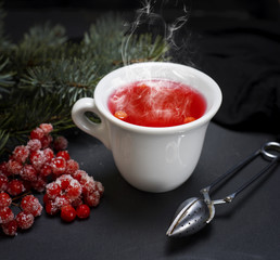 tea from fresh red viburnum in a white ceramic cup