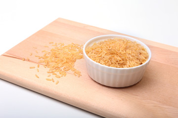 Rice in a bowl on wooden background. ready for cooking.