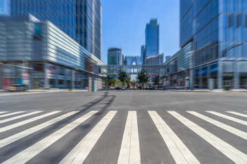 Fototapeta na wymiar empty road with zebra crossing and skyscrapers in modern city.