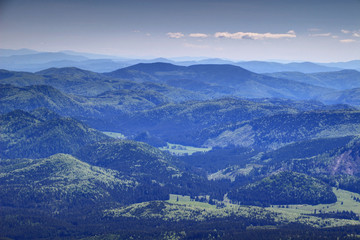 Gentle slopes covered with green forests of Slovenske Rudohorie Slovak Ore Mountains near Roznava and Dobsina in a sunny spring day from Kralova Hola peak, Low Tatras, Slovakia, Europe © nogreenabove2k