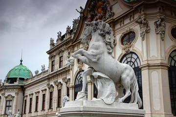 Fototapeta na wymiar Equine statue of white horse rearing on its hind legs in front of facade of Baroque style Upper Belvedere Palace former residence for Prince Eugene of Savoy, Vienna, capital city of Austria, Europe