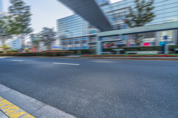 city empty traffic road with cityscape in background.