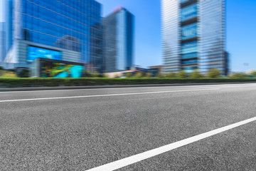 city empty traffic road with cityscape in background.