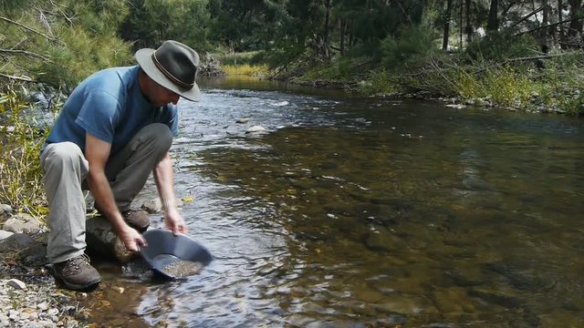 a prospector pans for gold at Sofala in Australia