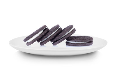 sandwich cookies with cream in white plate on white background