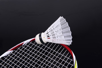 Badminton and tennis racket close-up, on a black background
