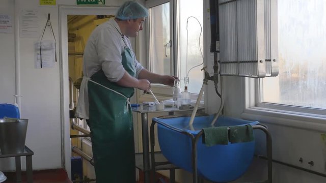Man in factory tests the potency of a batch with chemicals