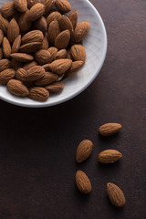 Whole almonds in white bowl