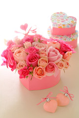 Valentine background.  Heart shaped  bouquet of beautiful pink rose flowers with heart ornaments