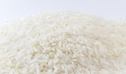 Fototapeta na wymiar Close up raw grain on white background. A pile of raw rice.