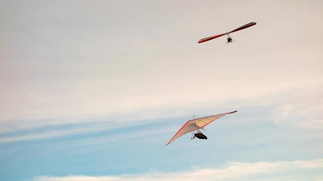 two hang gliders fly above cape byron, australia