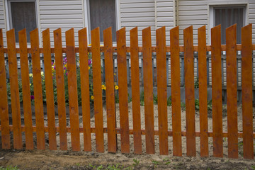 Long wooden cedar fence on the empty street.