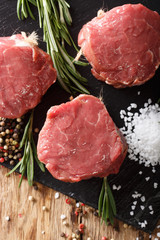 raw filet mignon steak with spices close up. Vertical top view
