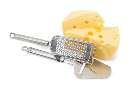 Cheese slicer and grater near of pieces of cheese