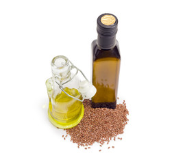 Two different bottles of linseed oil and pile of linseed