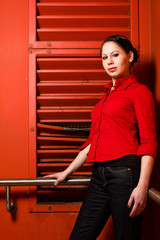 Young Woman In Front Of A Red Wall