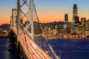 San Francisco Bay Bridge and Skyline at dusk. Clear evening over San Francisco waterfront with holiday lights from Yerba Buena Island, California, USA.