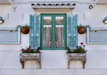 A colorful window with tavni in Greek style