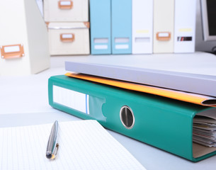 Folder file, note and pen on the desk. blurred background.