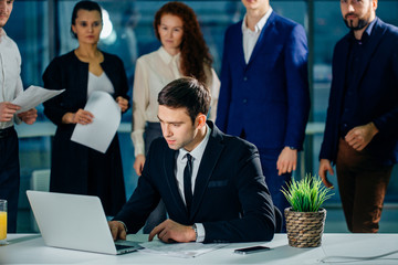 Business man working on laptop computer with business document, graph diagram and calculator on...