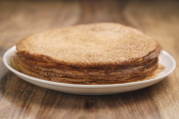 homemade crepes on plate on wood table