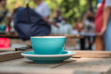 Blue coffee cup on wooden table,Close-up photo of blue coffee cup,The back is blurred.