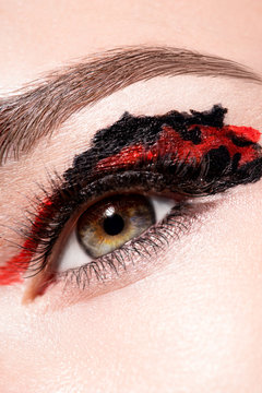 Woman eye with colorful makeup closeup