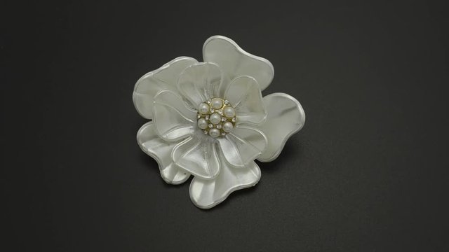 Brooch flower with pearls isolated on black