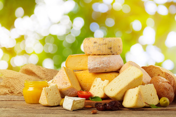 Variety of cheese types composition on wooden board