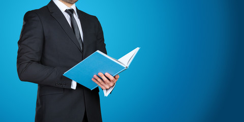 Unrecognizable businessman holding  a book