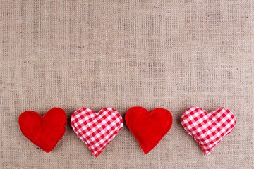 Valentines Day background with fabric hearts on sackcloth, copy space