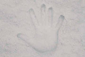 A handprint of a person's palm on the snow.