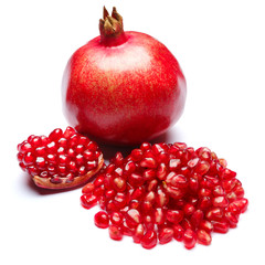 Pomegranate and seeds on white background close-up