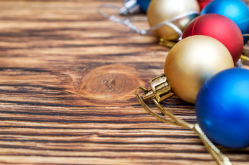 Christmas balls on the wooden background. New year background.