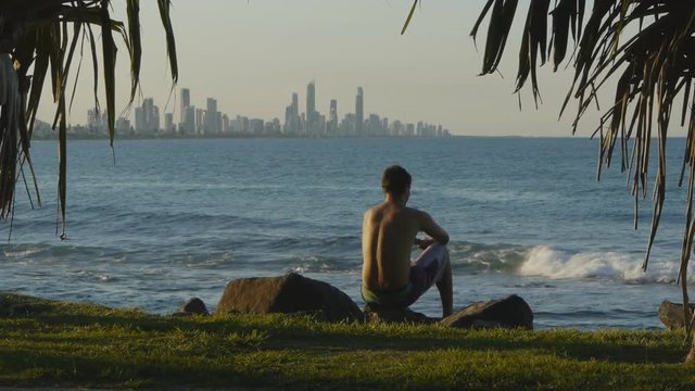 a man enjoys the view of surfers paradise from burleigh heads