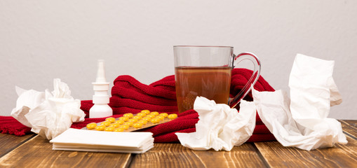 tea, nasal spray, tablets and handkerchiefs for illness